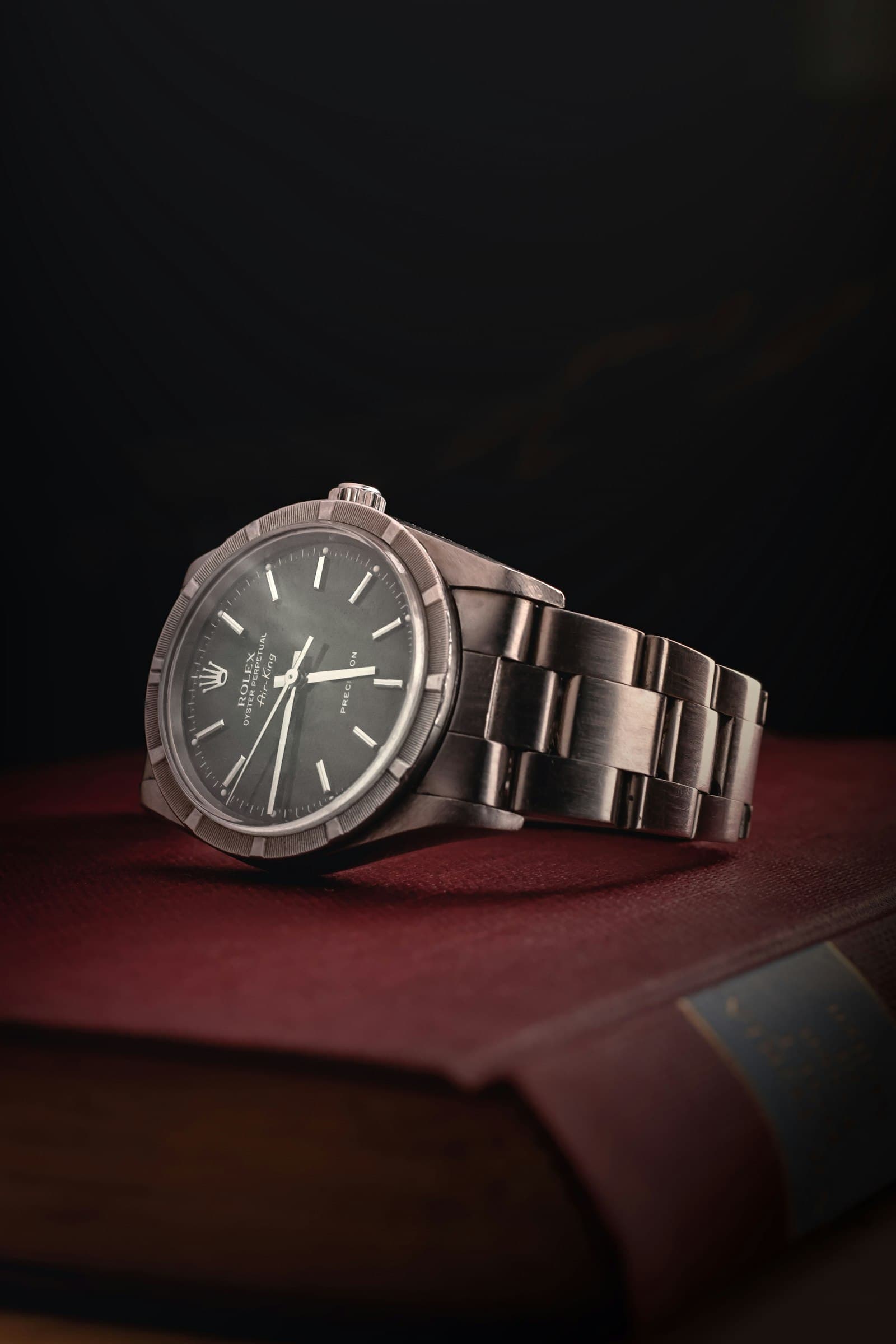 Collector reviewing a luxury watch before bidding