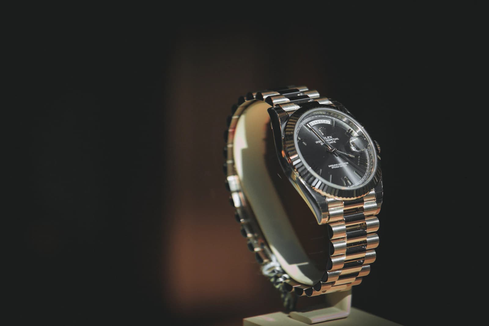 Luxury wristwatch with a metal bracelet on a dark background